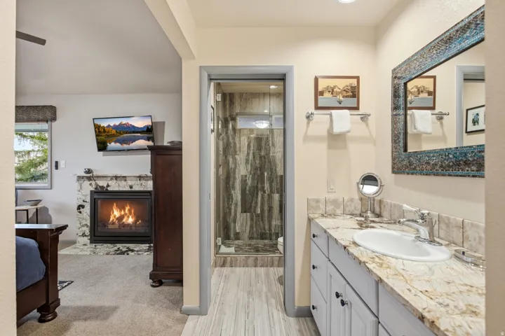 Bathroom vanity with a vessel sink and a framed mirror