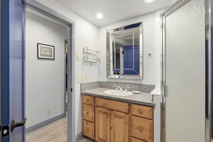Wood-finish vanity with an integrated sink and light-colored countertop