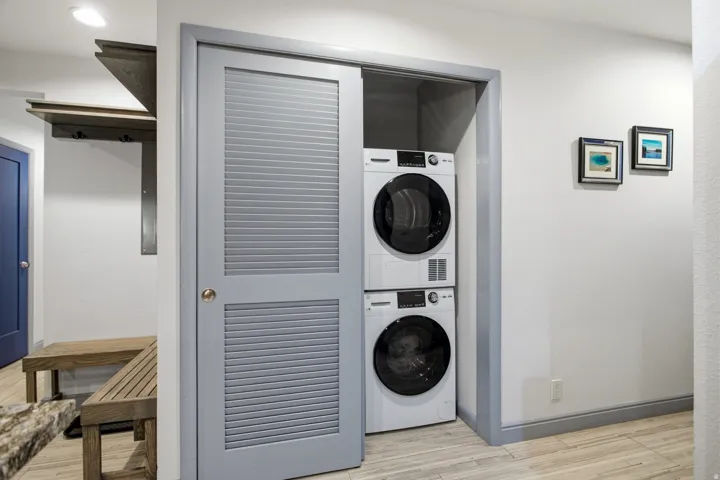 Stackable washer and dryer combination within a louvered bi-fold door closet
