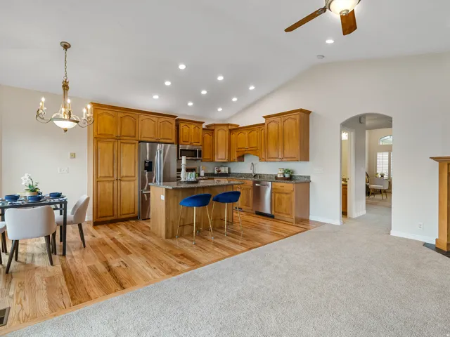Vaulted ceiling with recessed lighting and ceiling fan