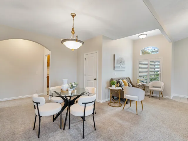 Recessed ceiling, decorative lighting fixture, arched entryway, upper arched window, and interior shutters