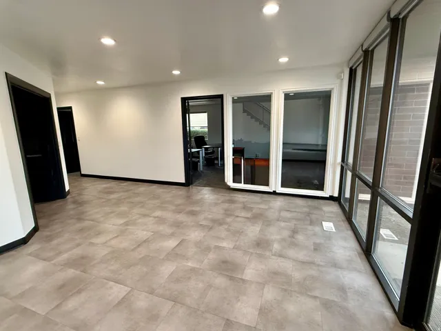 Recessed lighting, tile flooring, interior glass doors, and expansive floor-to-ceiling windows