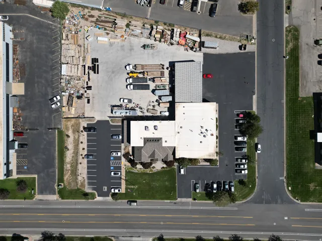 Expansive commercial property featuring multiple buildings, extensive paved parking areas, and significant outdoor storage space