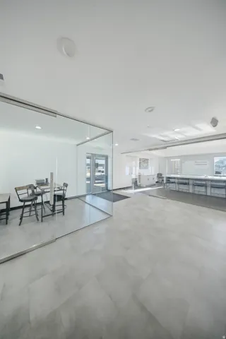 Recessed lighting, light-toned walls, and gray tile flooring