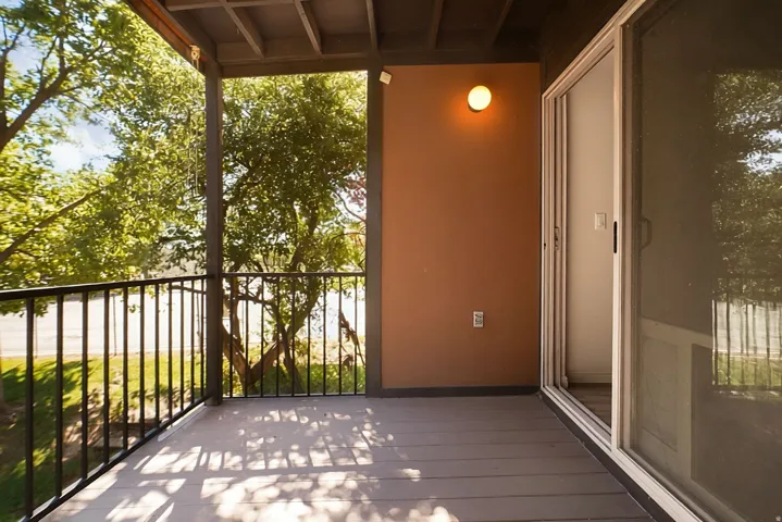 Private balcony featuring durable composite decking and black metal railings