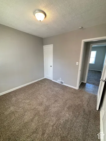 Neutral-toned walls and plush brown carpet