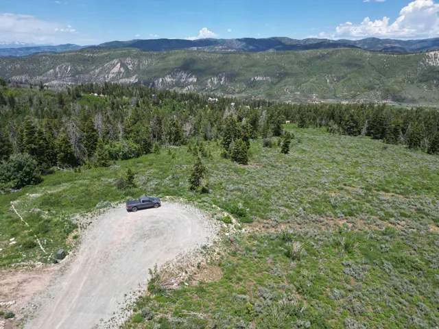 Expansive mountain terrain with a gravel access road