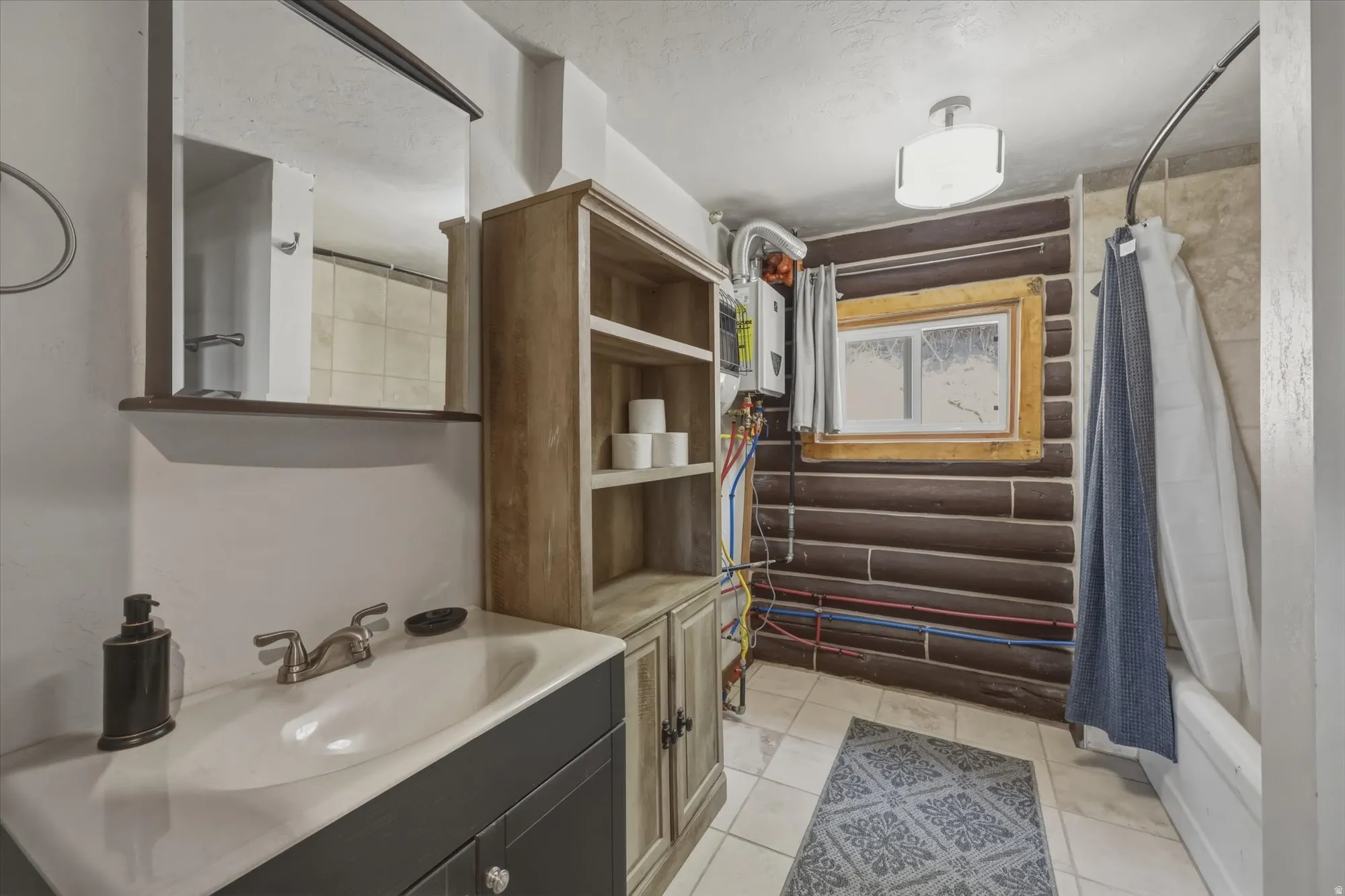 Built-in vanity with integrated sink, wall-mounted mirror, and wood-finish shelving unit