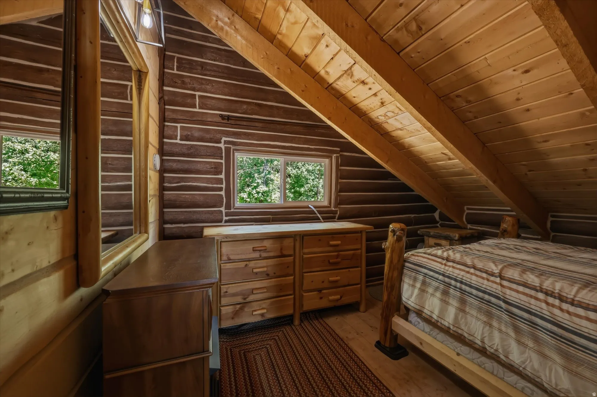 Log wall construction with exposed wood beams