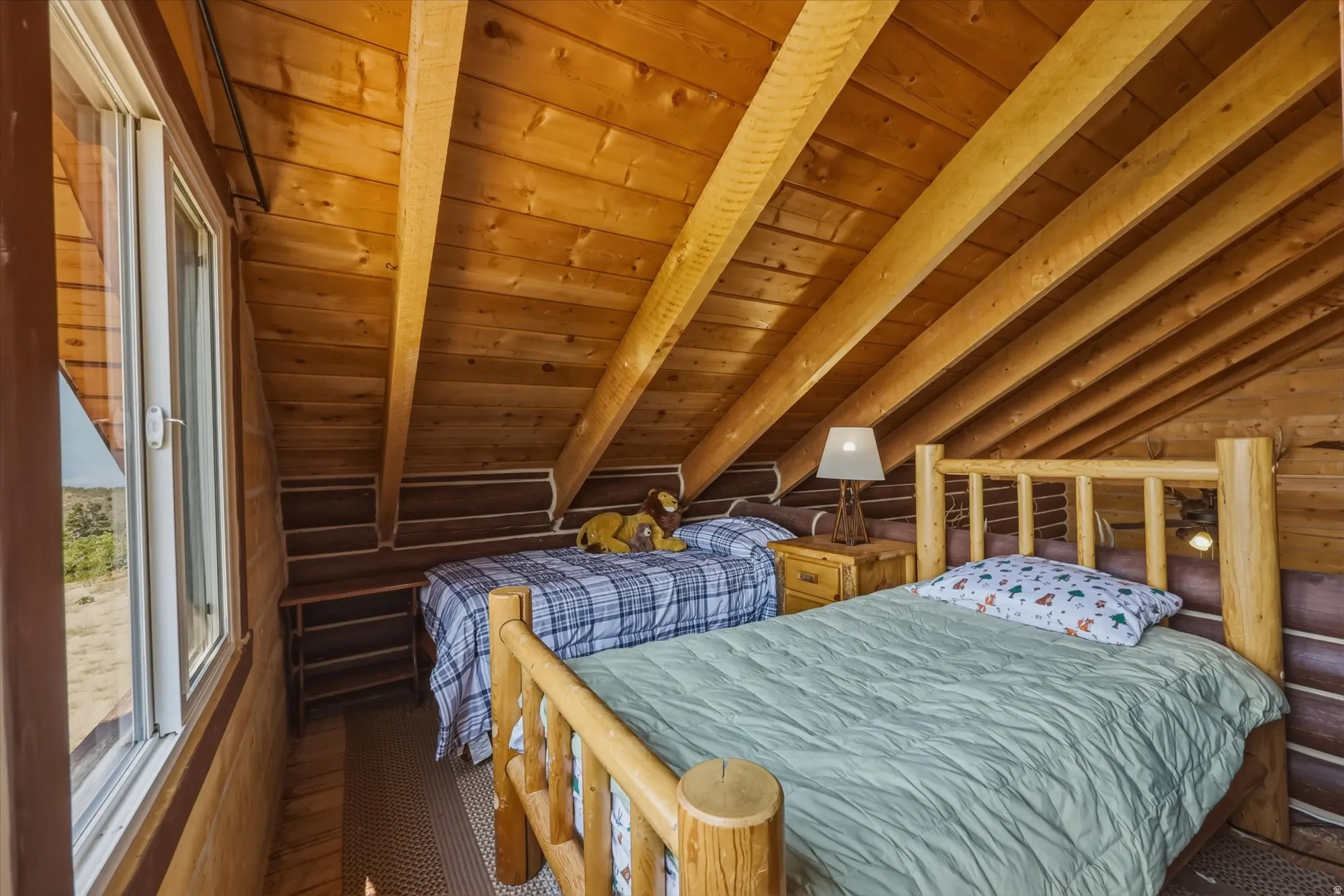 Wood-paneled sloped ceiling with exposed beams
