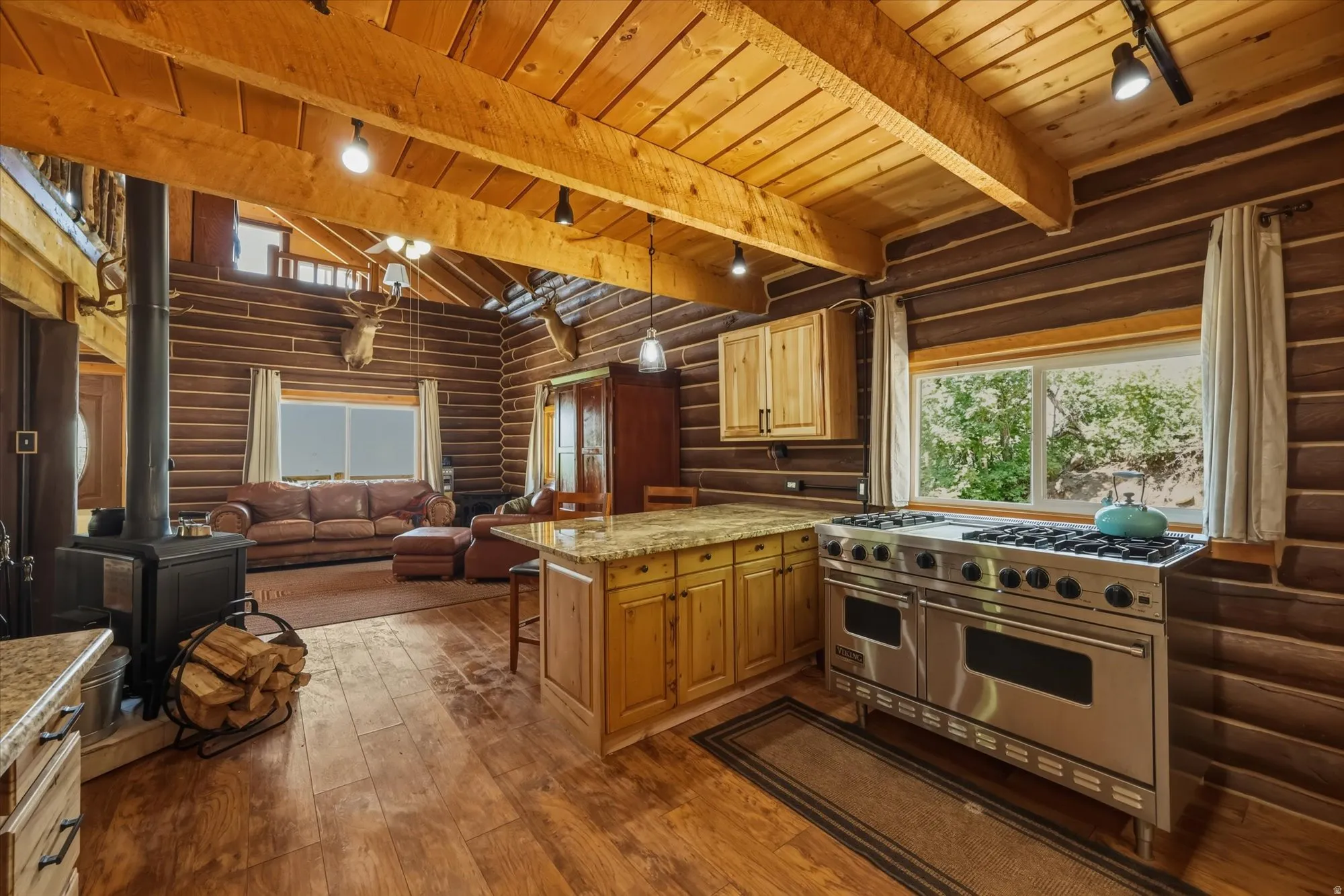 Log-style interior construction featuring exposed wood beams and wood-finish flooring