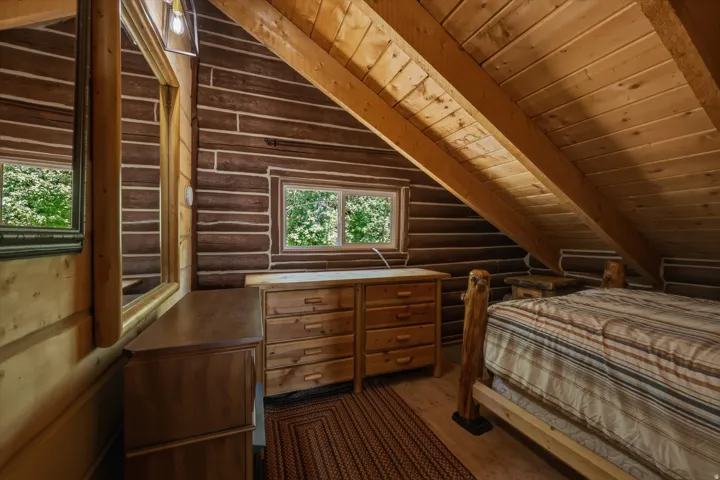 Log wall construction with exposed wood beams