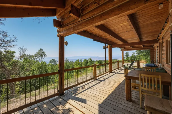 Expansive covered deck featuring natural wood flooring and structural timber beams