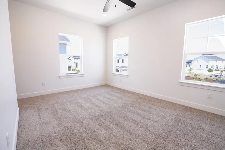 Primary bedroom with 9' ceiling and ceiling fan.