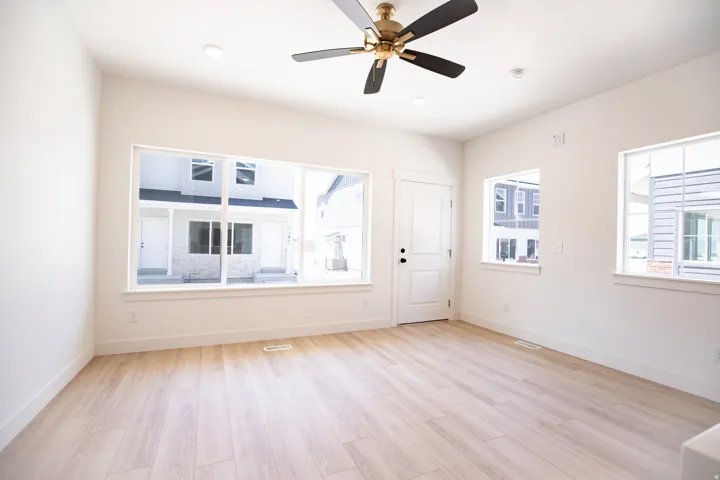 Family room with 9' ceiling and ceiling fan.