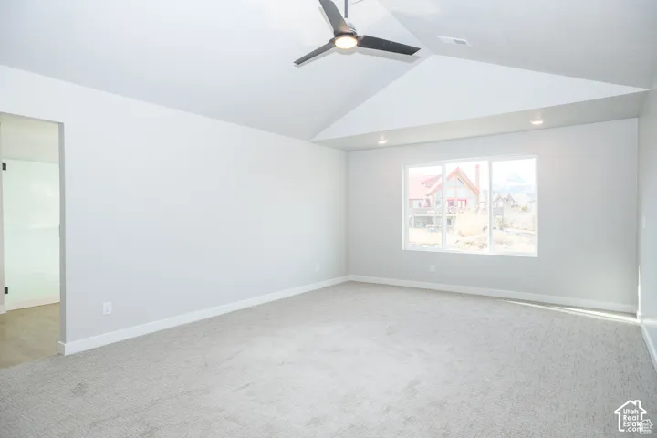 Vaulted ceilings, recessed lighting, and a modern ceiling fan