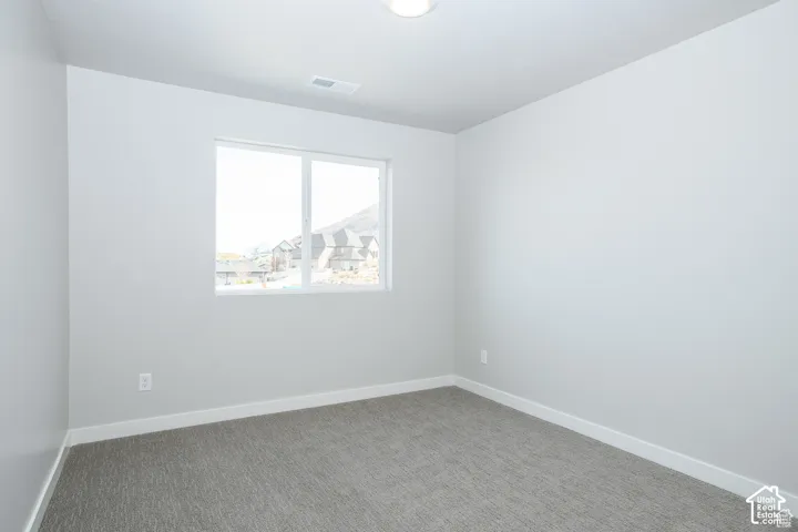 Recessed ceiling light, neutral wall paint, white trim, and carpet flooring