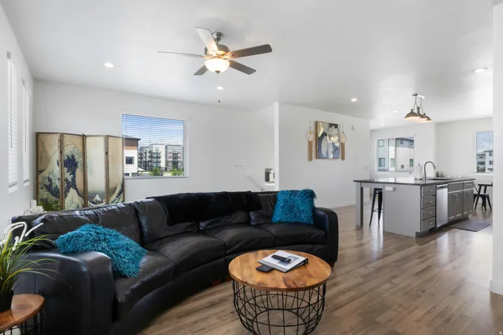 Wood-finish flooring throughout, recessed lighting, and a ceiling fan with integrated light fixture