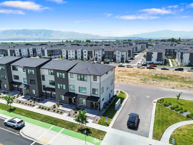 Modern multi-story residential buildings featuring dark gray and light-toned siding