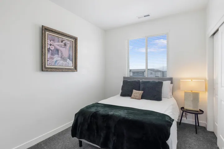 Recessed lighting, wall-to-wall carpeting, and a window with horizontal blinds
