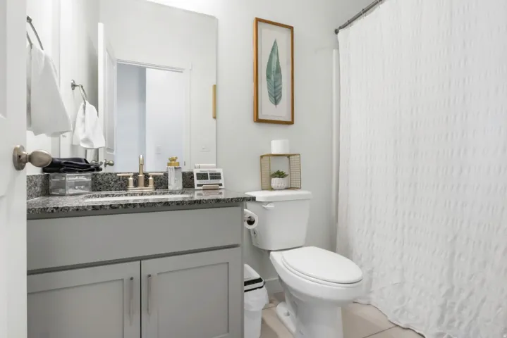 Vanity with granite countertop, undermount sink, and brushed brass fixtures