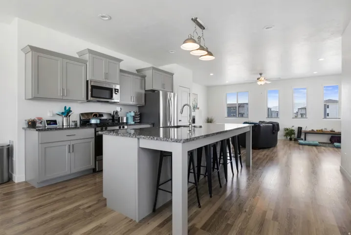 Open-concept living area featuring wood-finish flooring