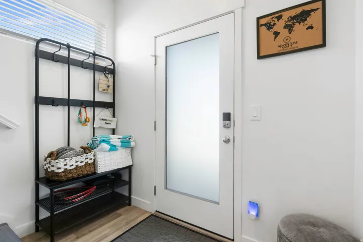 White entry door with frosted glass panel and smart lock hardware