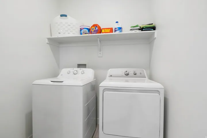 Dedicated laundry area with a built-in shelf