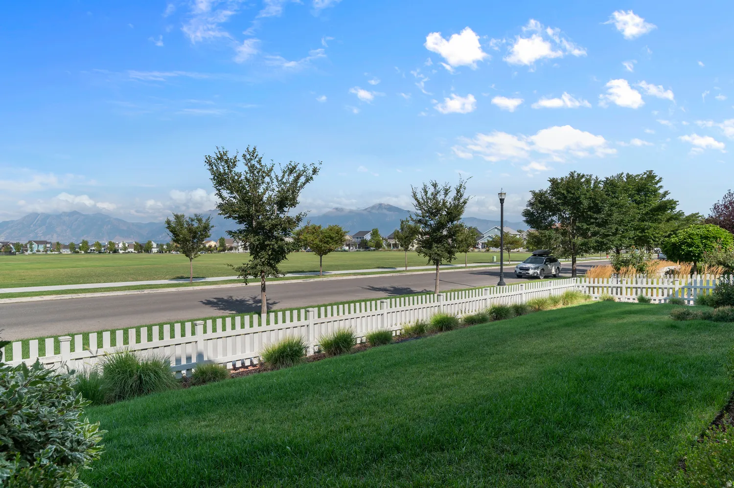 Manicured lawn with white picket fencing