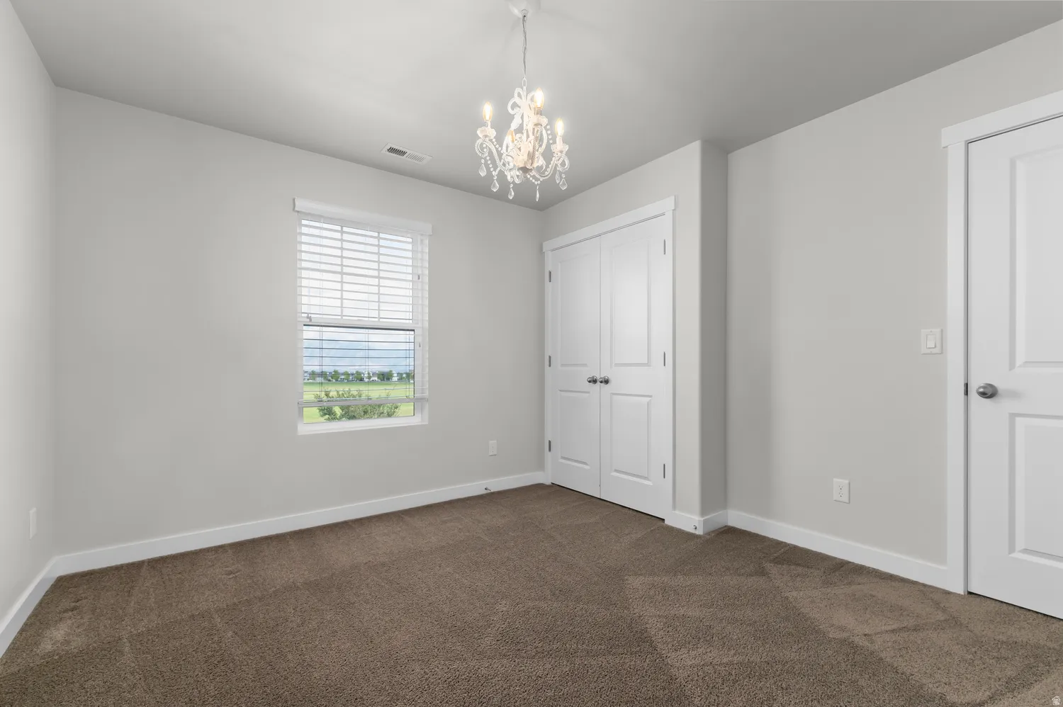 Neutral-toned walls complement the brown carpeting
