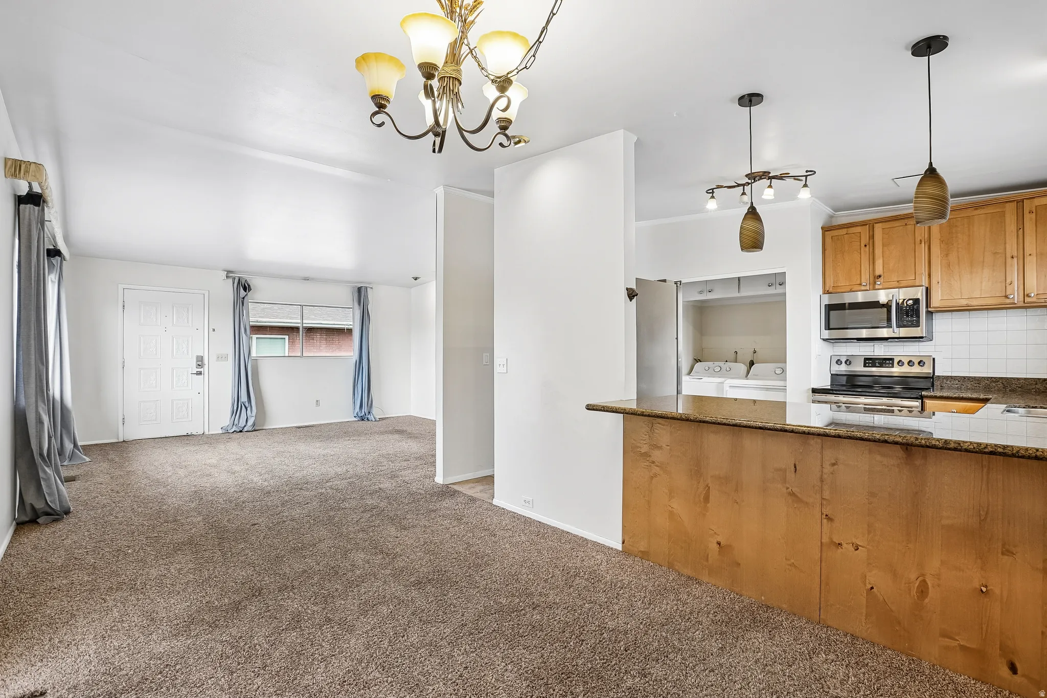 Kitchen featuring wood cabinetry, stainless steel appliances, and a breakfast bar