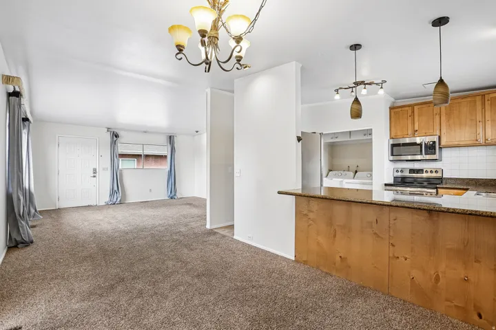 Kitchen featuring wood cabinetry, stainless steel appliances, and a breakfast bar