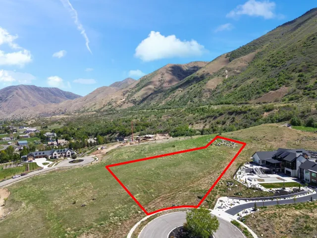 Expansive land parcel with surrounding mountainous terrain