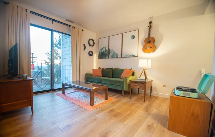 Wood-finish flooring, full-light glass patio door, and a private balcony