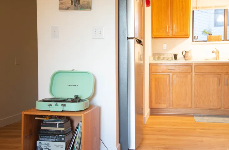 Kitchen featuring wood-finish cabinetry, solid surface countertops, and stainless steel refrigerator