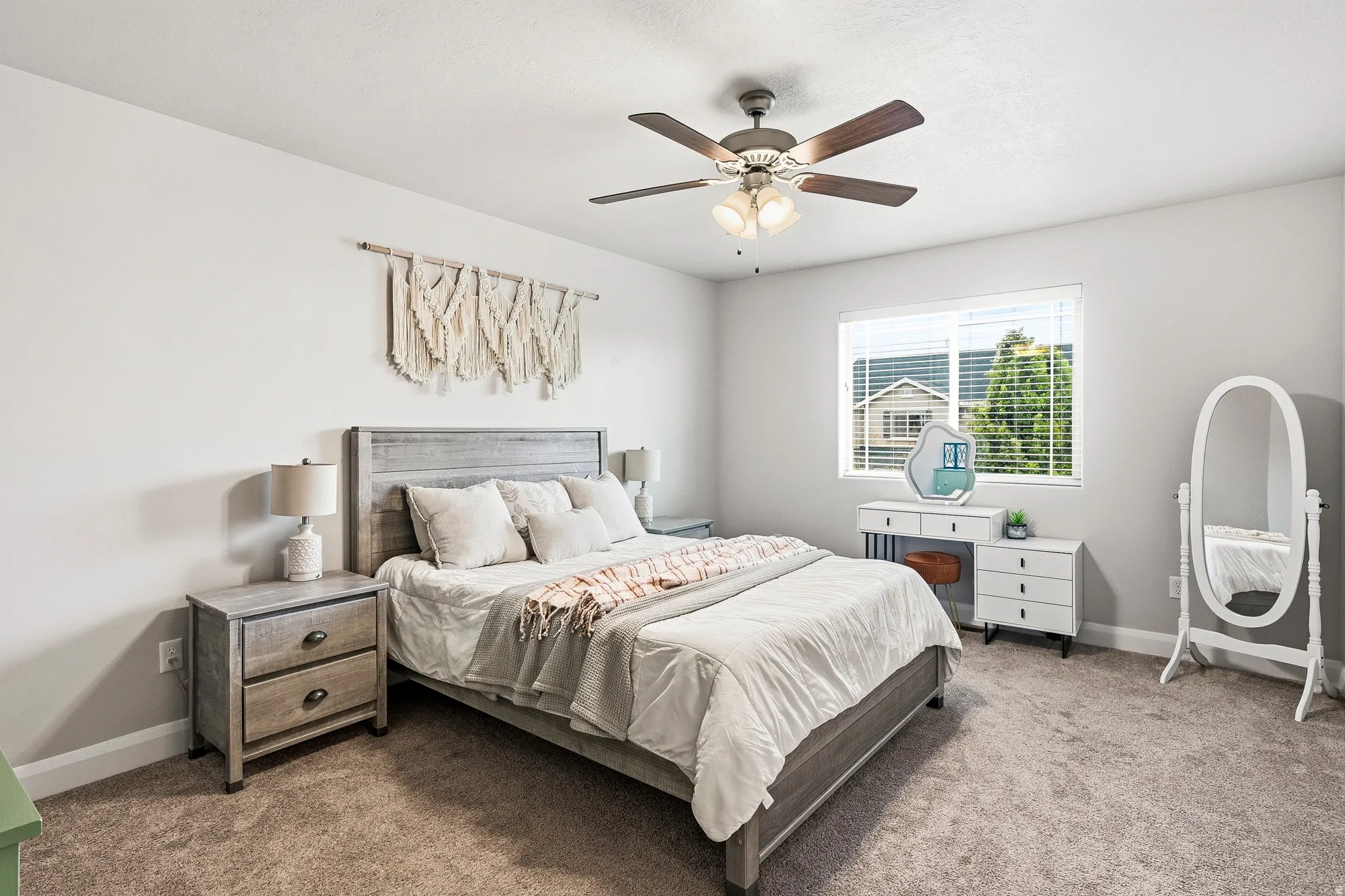 Recessed window with horizontal blinds, overhead ceiling fan with lighting, wood-finish flooring, and light-toned wall paint