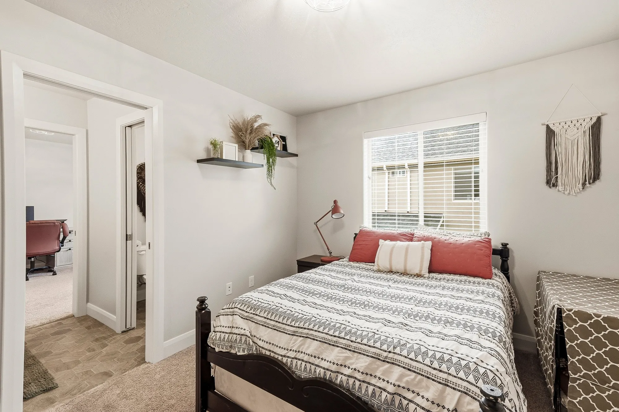 Recessed lighting illuminates neutral-toned walls and carpeted flooring