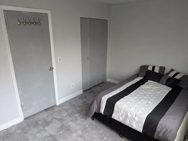 Gray-toned flooring, gray wall paint, and white trim