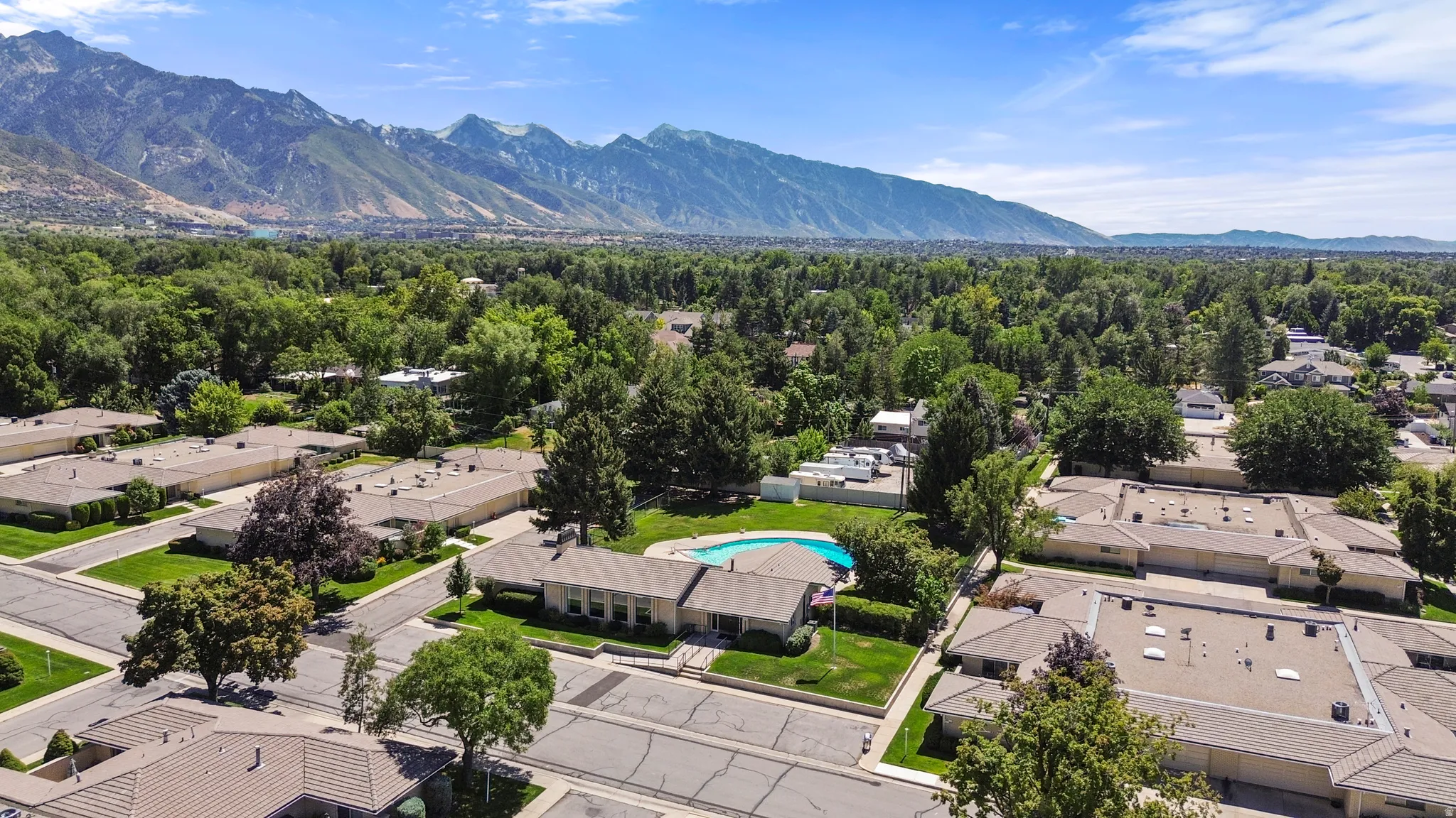 Mountain backdrop, residential neighborhood with abundant mature trees, well-maintained streets, and a private swimming pool