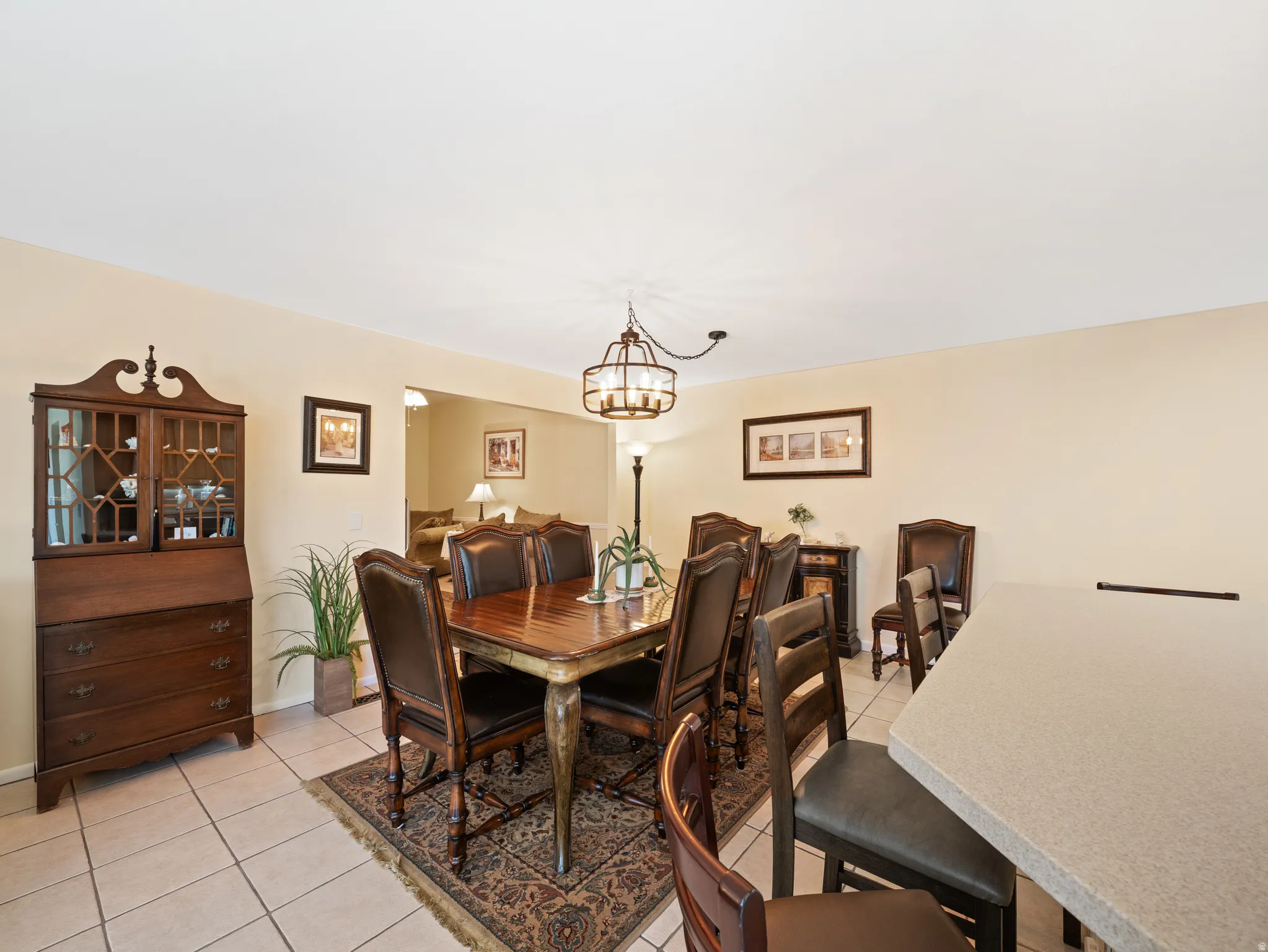 Recessed ceiling, neutral wall paint, tile flooring, and an open concept layout