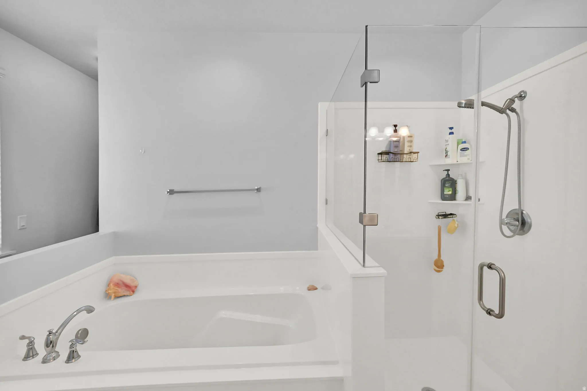 Soaking tub with deck-mounted faucet and handheld showerhead