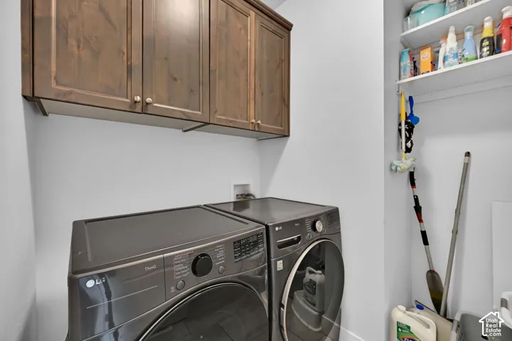 Built-in wooden cabinetry, white shelving, and a wall-mounted utility rack