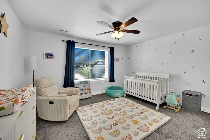 Recessed window with blinds, dark wood-finish ceiling fan, and light gray wall paint