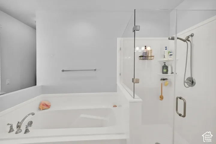 Soaking tub with deck-mounted faucet and handheld showerhead