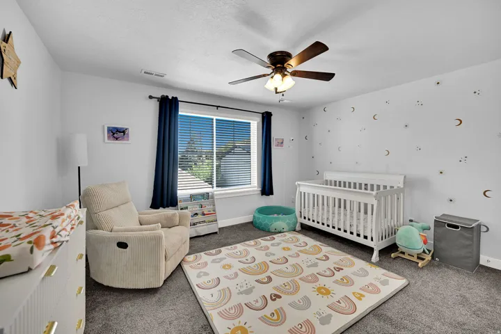 Recessed window with blinds, dark wood-finish ceiling fan, and light gray wall paint