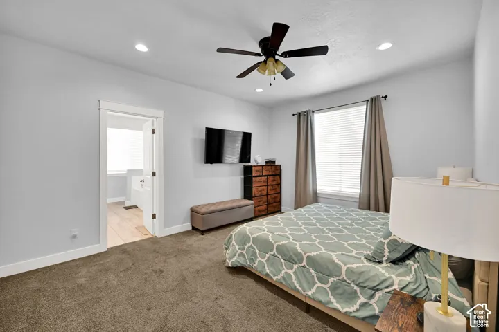 Recessed lighting, ceiling fan, carpet flooring, large window with blinds, and an entryway to another room