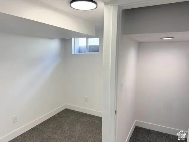 Recessed window, plush gray carpeting, white walls, and contemporary ceiling lighting