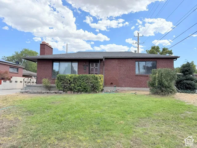 Brick exterior architecture with a dark shingle roof