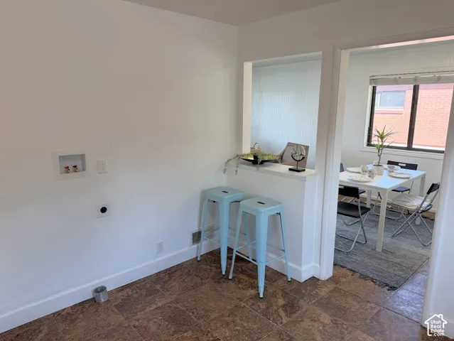 Laundry hookups, wood-finish flooring, and a pass-through window with a half wall