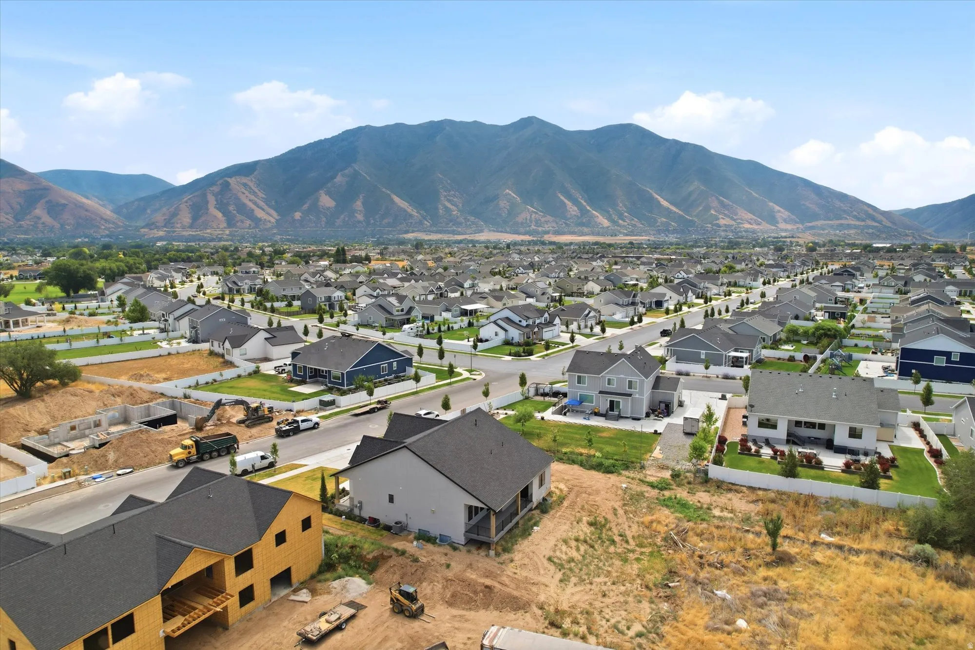 Expansive community with varied architectural styles set against a prominent mountain backdrop
